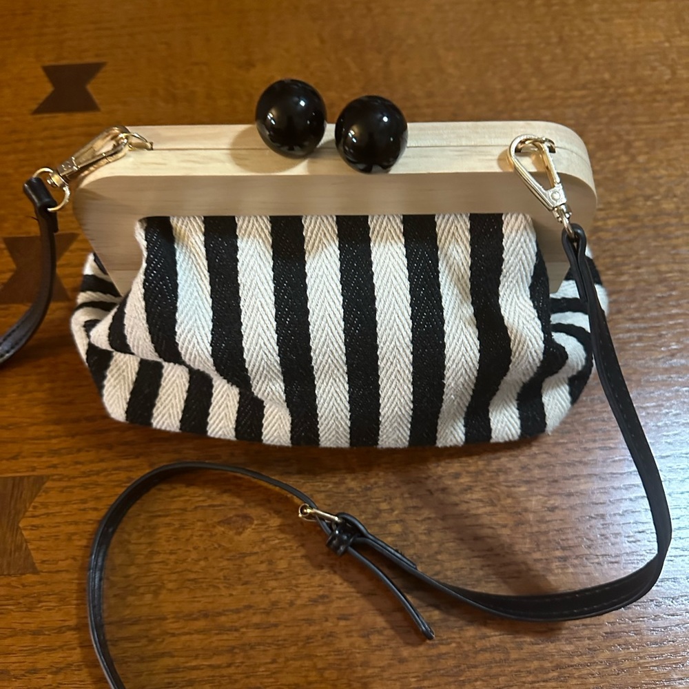 Adorable Black & Cream Striped Crossbody Bag. Snap closure. Measures 20”…